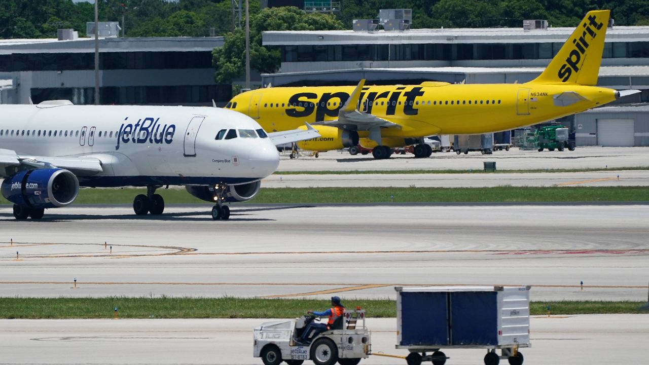 A JetBlue Airways Airbus A320, left, passes a Spirit Airlines Airbus A320 as it taxis on the runway, July 7, 2022, at the Fort Lauderdale-Hollywood International Airport in Fort Lauderdale, Fla. (AP Photo/Wilfredo Lee, File) 
