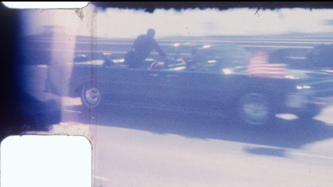 An undated image released by RR Auction shows home film footage of President John F. Kennedy's motorcade speeding down a Dallas freeway to the hospital after he was fatally wounded on Nov. 22, 1963. (RR Auction via AP, File)