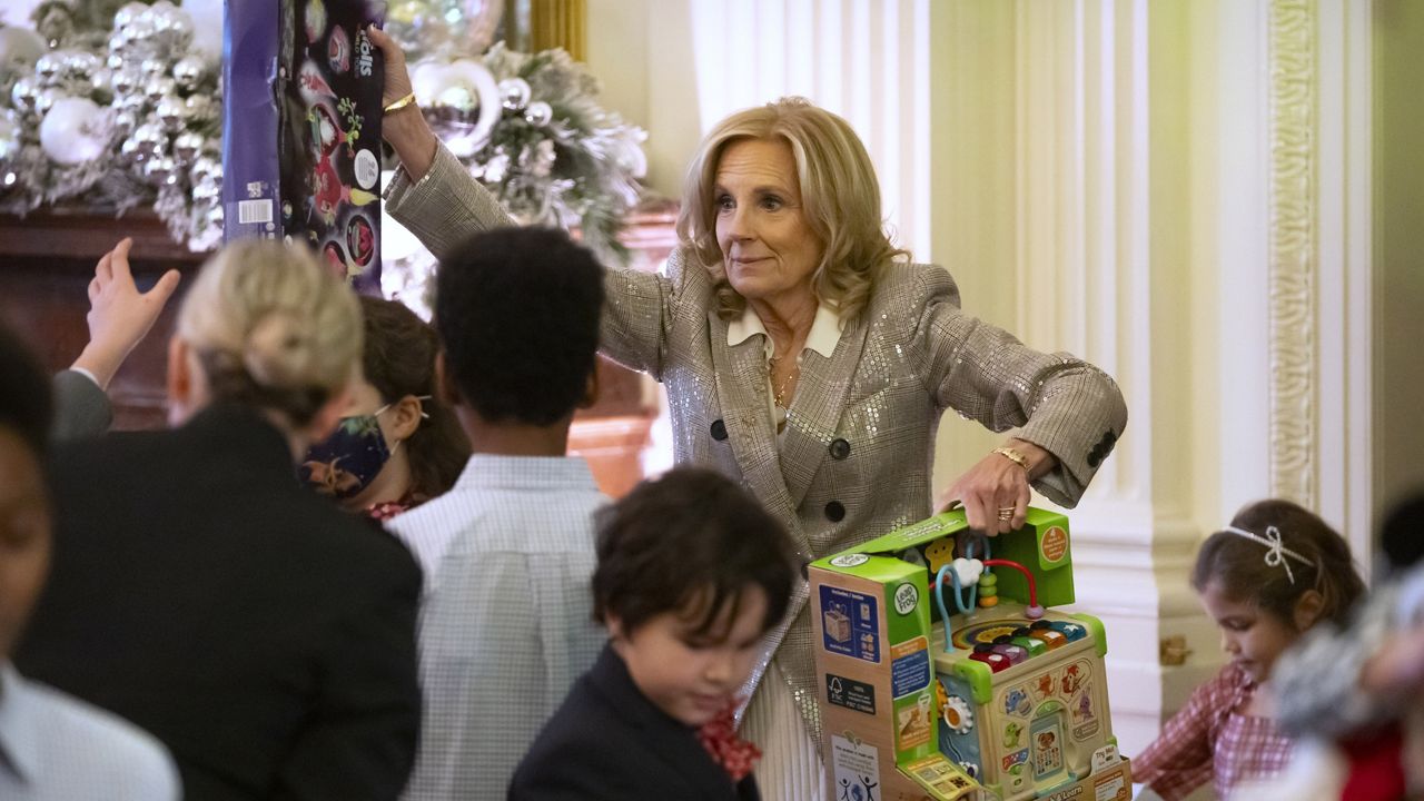 First lady Jill Biden helps to sort toys as she hosts a Toys for Tots event with Marine Corps families in the East Room at the White House in Washington, Friday, Dec. 13, 2024. (AP Photo/Mark Schiefelbein)