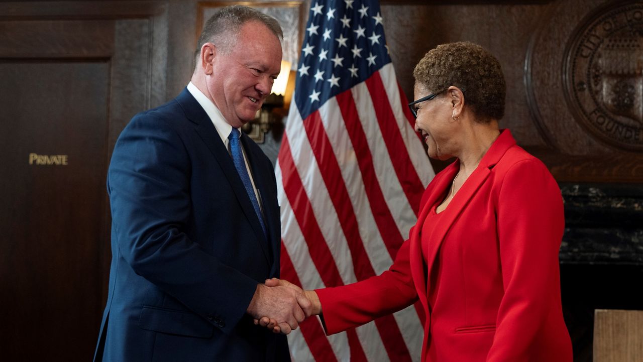 Los Angeles Mayor Karen Bass, right, and newly appointed police chief Jim McDonnell shake hands during a news conference Friday in Los Angeles. (AP Photo/Jae C. Hong)