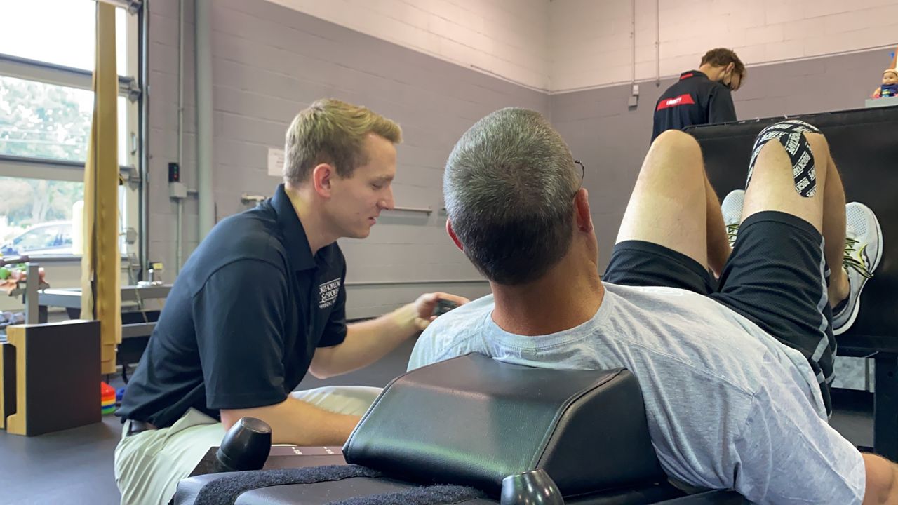 A physical therapist works on strength exercises with his patient. New York Gov. Kathy Hochul will consider signing a bipartisan bill that passed at the end of session to permit physical therapy assistants to work under general supervision, or receive oversight from a PT who does not have to be physically present on-site during treatment. (Spectrum News 1/Diamond Palmer)
