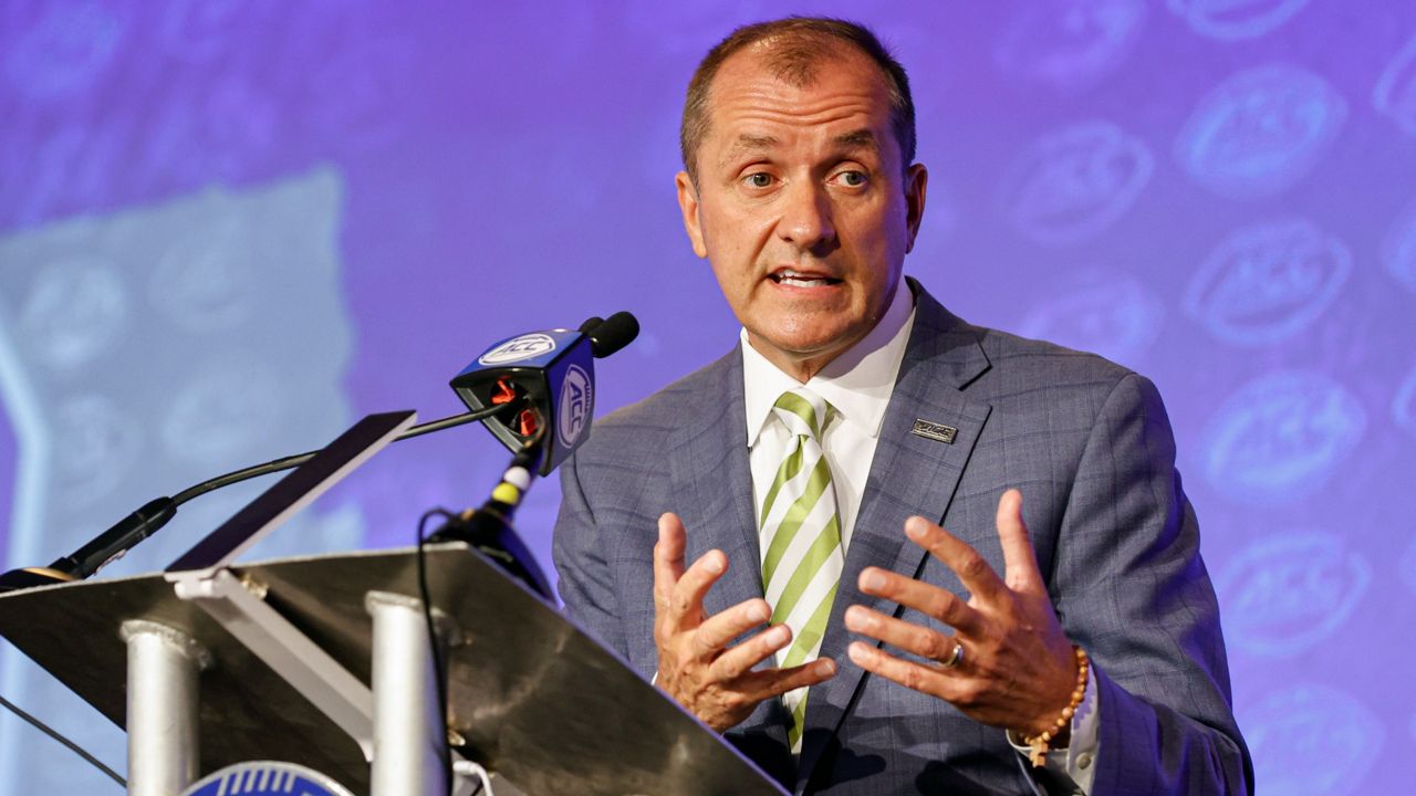 Atlantic Coast Conference Commissioner Jim Phillips answers a question during an NCAA college football news conference at the ACC media days in Charlotte, N.C., Wednesday, July 20, 2022. Phillips says he never “condoned or tolerated inappropriate conduct” against athletes as Northwestern's athletics director in the wake of that school's hazing scandal, which has led to at least three lawsuits and the firing of football coach Pat Fitzgerald. (AP Photo/Nell Redmond, File)