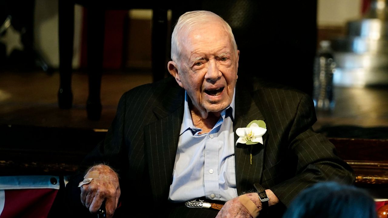 Former President Jimmy Carter reacts as his wife Rosalynn Carter speaks during a reception to celebrate their 75th wedding anniversary on Saturday, July 10, 2021 in Plains, Ga.