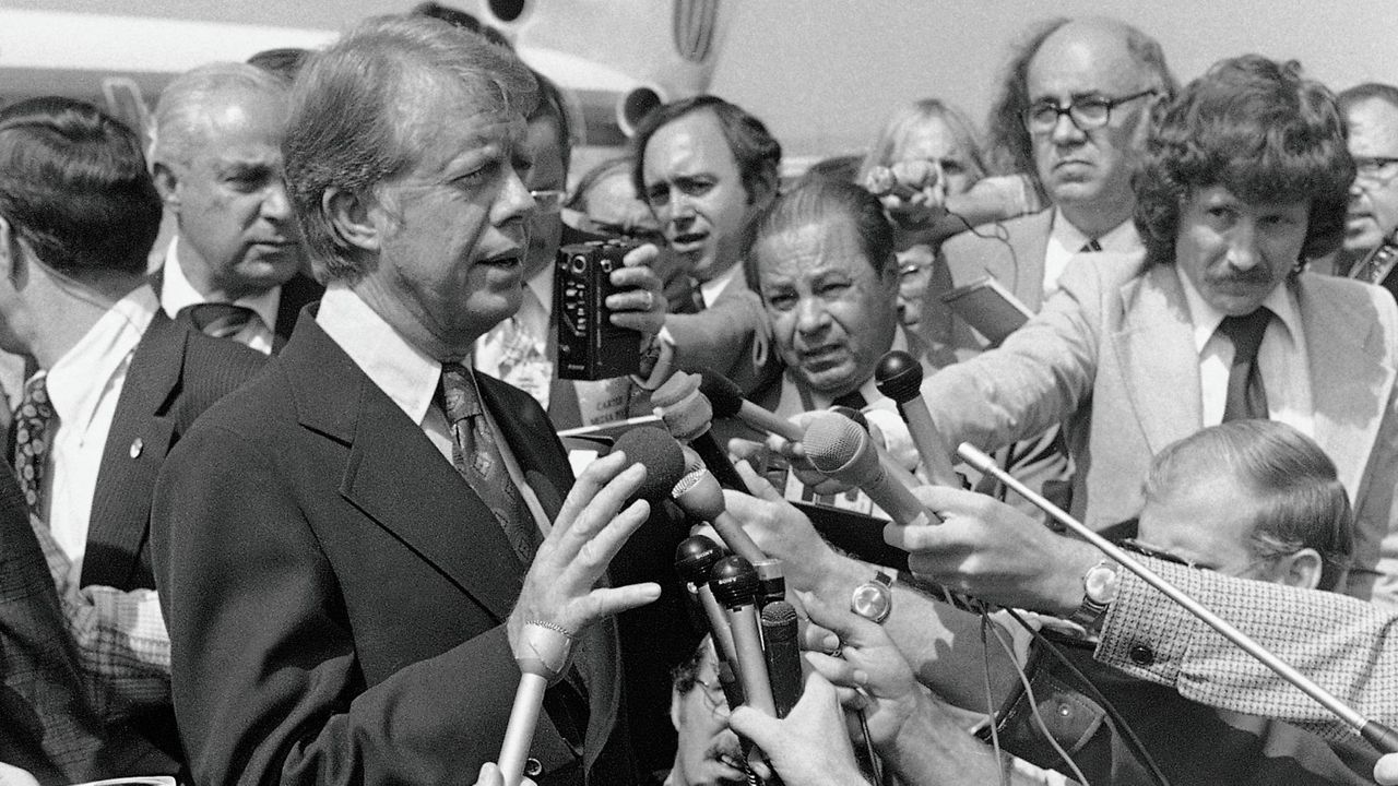 Then Democratic presidential nominee Jimmy Carter speaks to reporters on his arrival at Hobby International Airport in Houston on Sept. 24, 1976. (AP Photo/Jack Thornell, File)