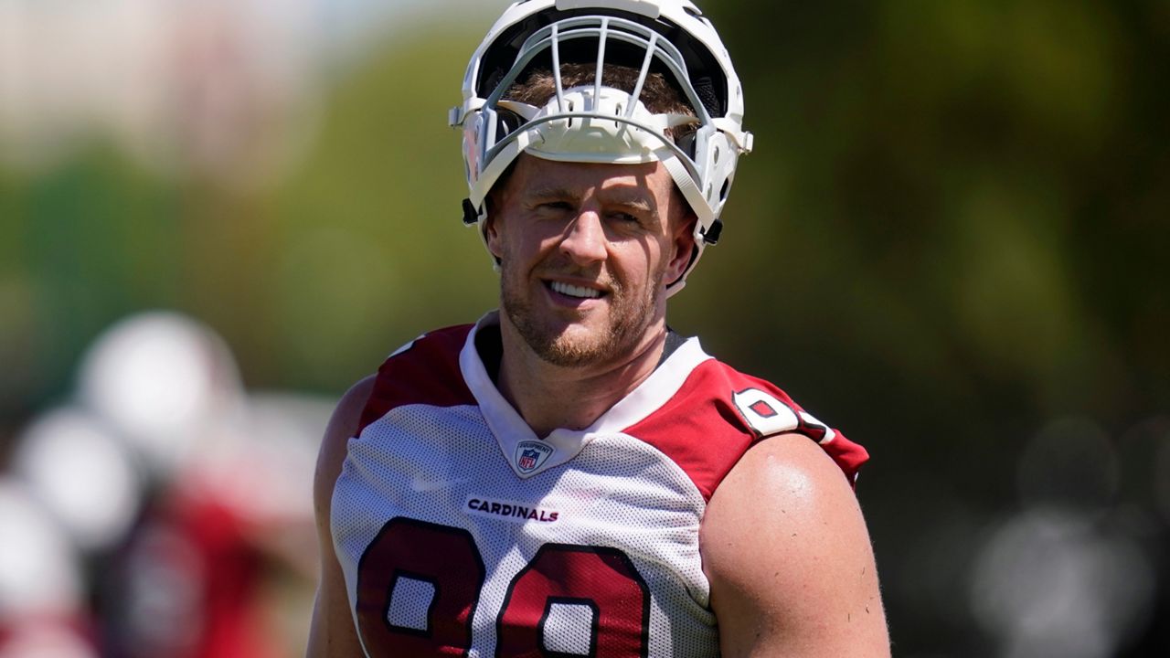 Arizona Cardinals defensive lineman J.J. Watt pauses on the practice field as he takes part in drills at the NFL football team's practice facility Tuesday, June 14, 2022, in Tempe, Ariz. (AP Photo/Ross D. Franklin)