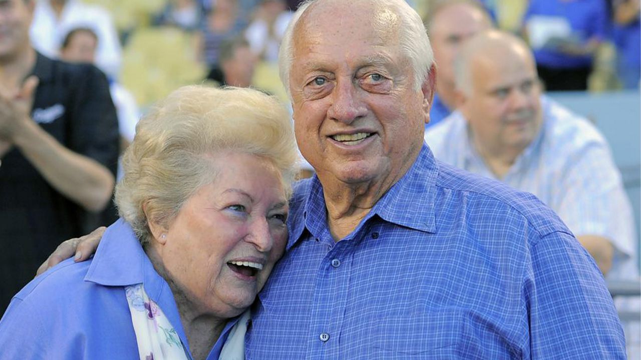 Tommy Lasorda and his wife Jo hug as they watch a video tribute to Tommy prior to the Dodgers' baseball game against the Colorado Rockies in Los Angeles, in this Sept. 28, 2013, file photo. (AP Photo/Mark J. Terrill)