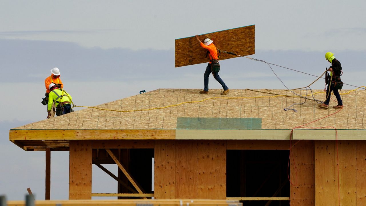 Work is done on the roof of a building under construction in Sacramento, Calif., on March 3. (AP Photo/Rich Pedroncelli)