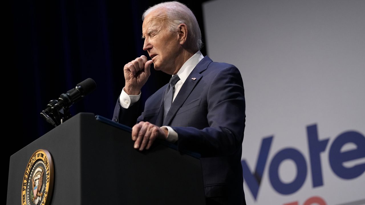 President Joe Biden coughs during an event with Rep. Steven Horsford, D-Nev., in Las Vegas, Tuesday, July 16, 2024. Biden tested positive for COVID-19 a day later. (AP Photo/Susan Walsh)