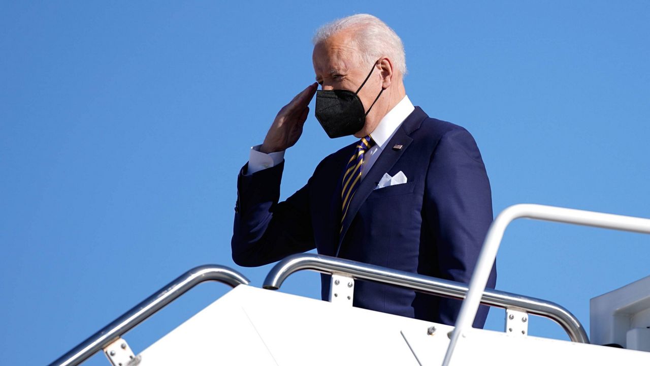 President Joe Biden salutes as he boards Air Force One on Tuesday at Andrews Air Force Base in Maryland. (AP Photo/Patrick Semansky)