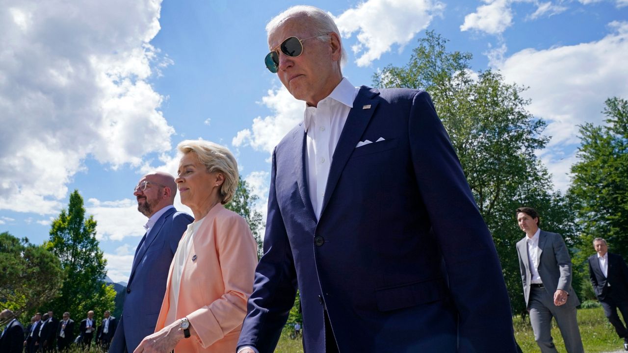 President Joe Biden, right, walks with Sunday European Commission President Ursula von der Leyen, center, and European Council President Charles Michel, left, as they head to a family photo with the G-7 leaders at the G-7 Summit in Elmau, Germany. (AP Photo/Susan Walsh, Pool)