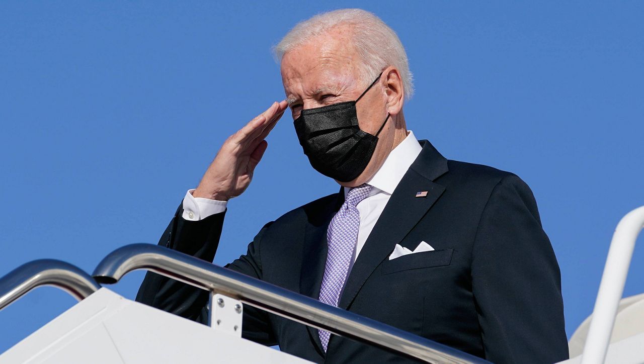 President Joe Biden salutes as he boards Air Force One at Joint Base Andrews in Maryland on Oct. 20. (AP Photo/Susan Walsh)