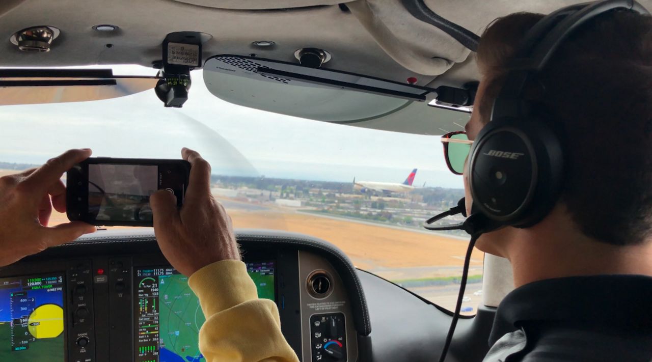 A pilot in a cockpit of a plane.