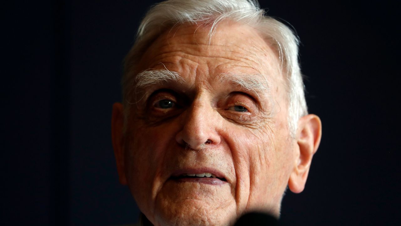 Nobel chemistry winner John B. Goodenough poses for the media at the Royal Society in London, Wednesday, Oct. 9, 2019. The 2019 Nobel Prize in Chemistry has been awarded to John B. Goodenough, M. Stanley Whittingham and Akira Yoshino for the development of lithium-ion batteries. (AP Photo/Alastair Grant)