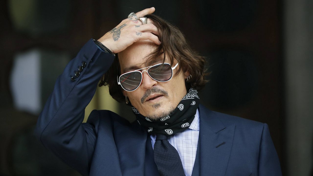 In this July 14, 2020 file photo, American actor Johnny Depp gestures to the media as he arrives at the High Court in London. (AP Photo/Matt Dunham)