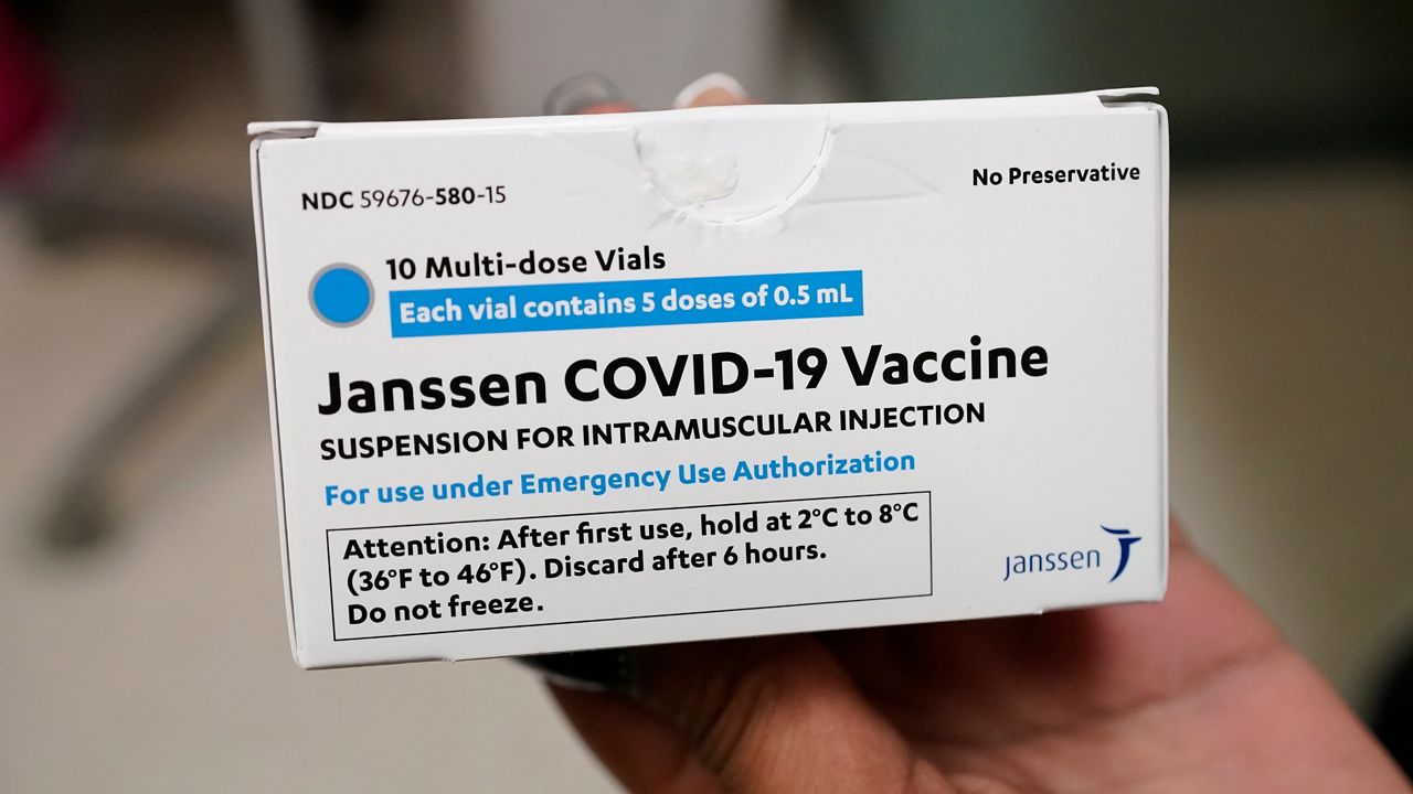 A package of the Johnson & Johnson COVID-19 vaccine is handled in this file image. (Associated Press)