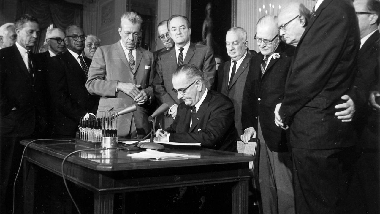 President Lyndon Johnson signs the Civil Rights Act on July 2, 1964, in the East Room of the White House. (AP)