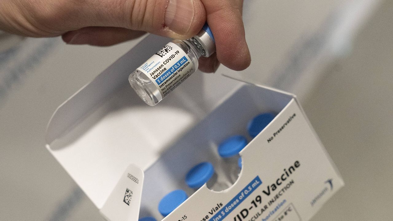 Pharmacist Jack Kann displays a vial of the Johnson & Johnson COVID-19 vaccine at South Shore University Hospital in Bay Shore, N.Y., on Wednesday. (AP Photo/Mark Lennihan)