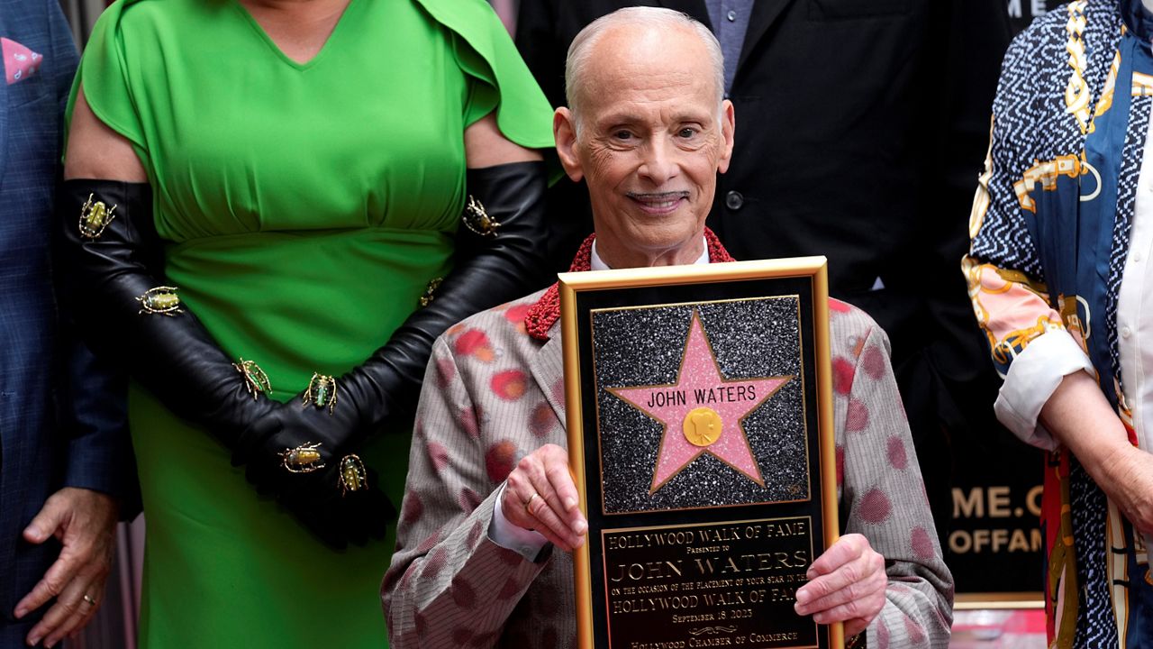 John Waters holds a replica of his new star during a ceremony honoring him with a star on the Hollywood Walk of Fame Monday, Sept. 18, 2023, in Los Angeles. (AP Photo/Chris Pizzello)