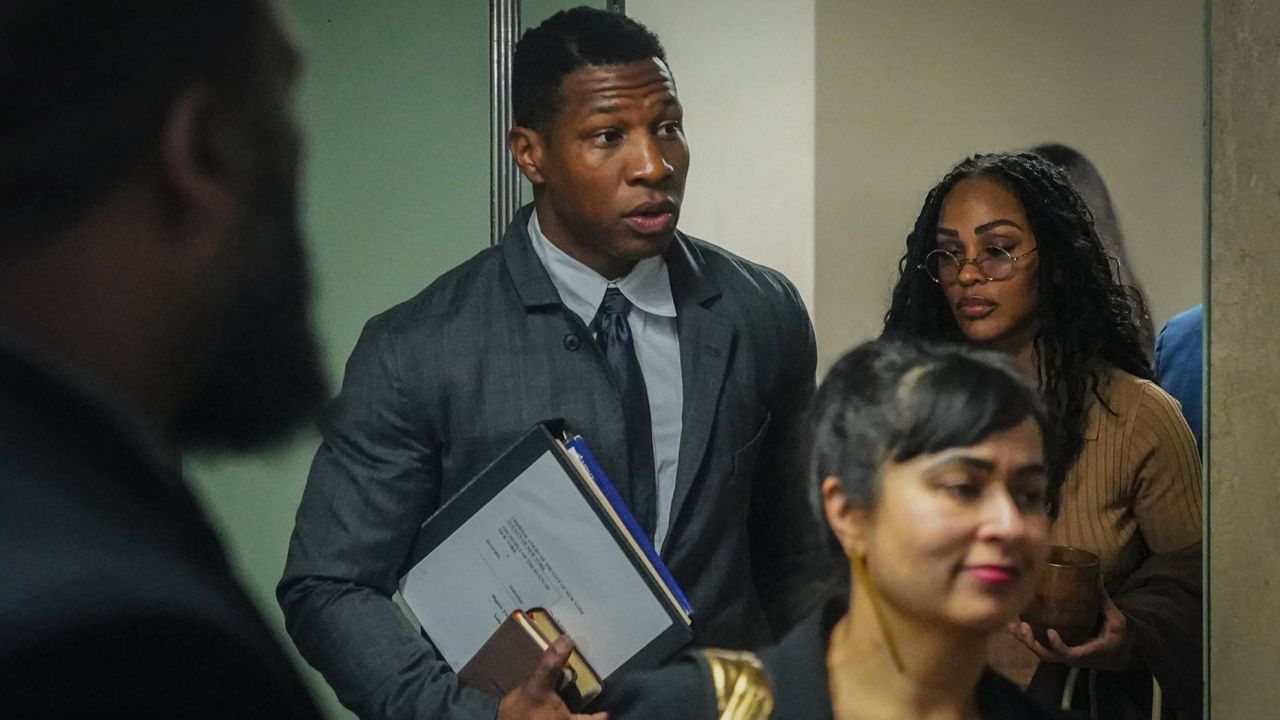 Actor Jonathan Majors, center, arrives at court for his domestic abuse trial Tuesday in New York. (AP Photo/Bebeto Matthews)