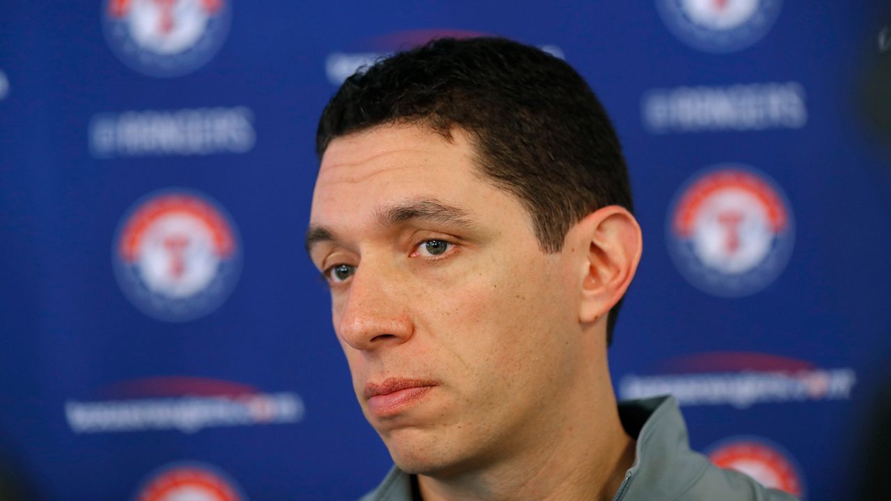 Texas Rangers general manager Jon Daniels speaks to reporters during baseball spring training in Surprise, Ariz., Feb. 15, 2018. Daniels is out as president of baseball operations for the Texas Rangers after 17 years leading the club. Team owner Ray Davis said Wednesday, Aug. 17, 2022, that Daniels was being relieved of his duties immediately after the decision was made not to renew his contract at the end of the season. (AP Photo/Charlie Neibergall, File)