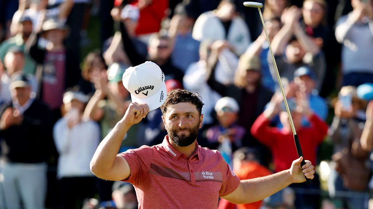 Jon Rahm celebrates on the 18th green after winning the Genesis Invitational golf tournament at Riviera Country Club, Sunday, Feb. 19, 2023, in the Pacific Palisades area of Los Angeles. (AP Photo/Ryan Kang)