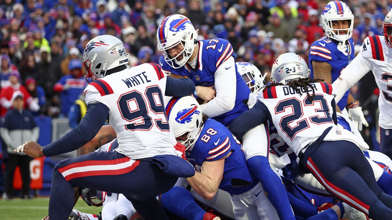 Buffalo Bills quarterback Josh Allen scores a touchdown during the second half of an NFL football game against the New England Patriots in Orchard Park, N.Y., Sunday, Dec. 31, 2023. (AP Photo/Jeffrey T. Barnes )