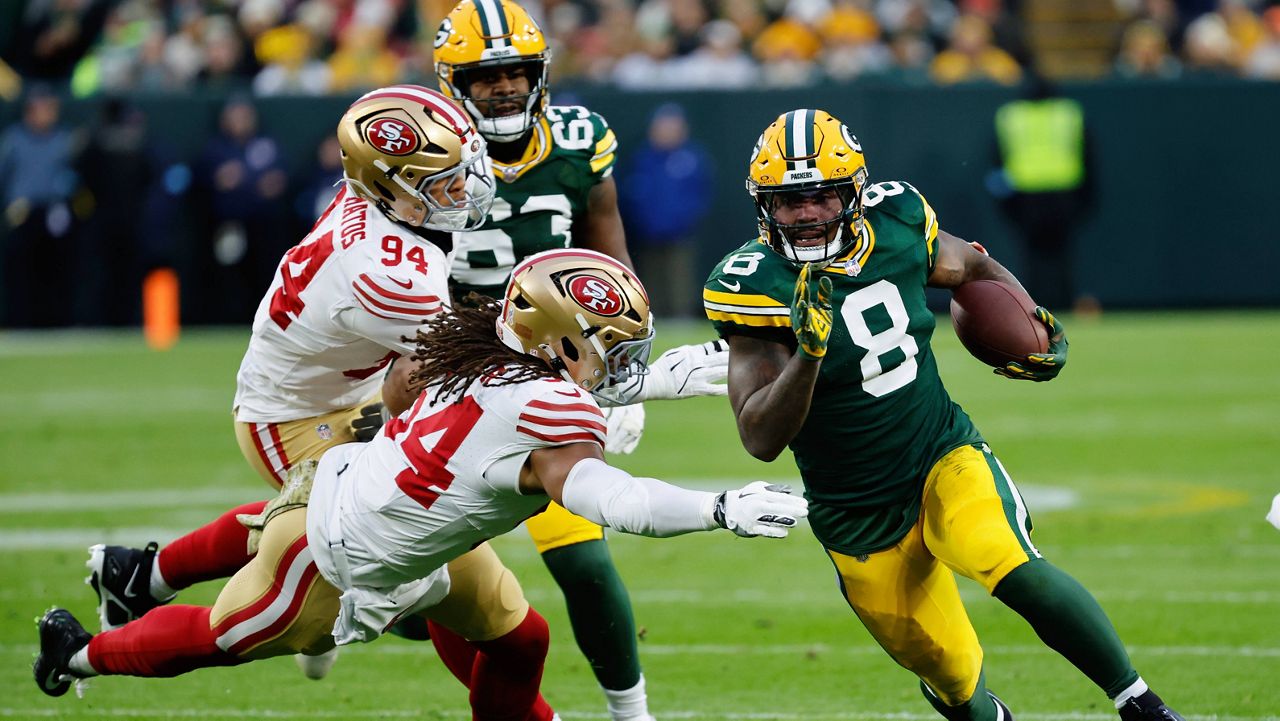 Green Bay Packers running back Josh Jacobs (8) runs the ball during the first half of an NFL football game