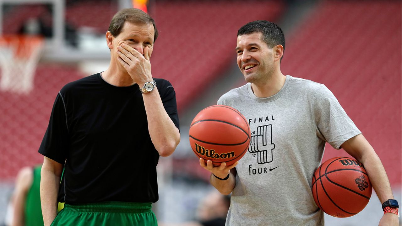 Oregon head coach Dana Altman, left, laughs with director of basketball operations Josh Jamieson during a practice session for their NCAA Final Four tournament college basketball semifinal game Friday, March 31, 2017, in Glendale, Ariz. Jamieson was added to Kenny Payne's coaching staff at the University of Louisville on Wednesday. (AP Photo/Mark Humphrey)