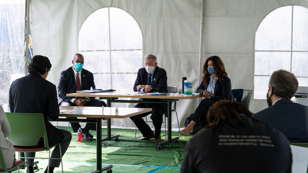 Los Angeles City Council member Kevin de Leon, far left, addresses U.S. District Judge Andre Birotte, second from left, U.S. District Court Judge David Carter, middle, and special master Michele Martinez, right, at a court hearing inside a tent at Downtown Women's Center in Los Angeles, Thursday, Feb. 4, 2021. (AP Photo/Damian Dovarganes)