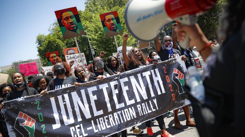 FILE- In this June 19, 2020, file photo, protesters chant as they march after a Juneteenth rally at the Brooklyn Museum, in the Brooklyn borough of New York. (AP Photo/John Minchillo, File)