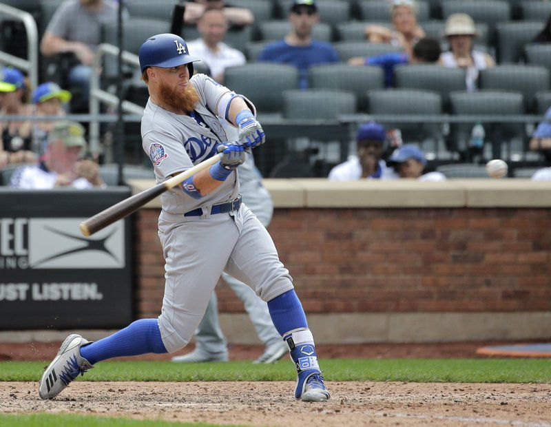 Los Angeles Dodgers’ Justin Turner hits a solo home run during the 11th inning of a baseball game against the New York Mets at Citi Field, Sunday, June 24, 2018, in New York. (AP Photo/Seth Wenig)