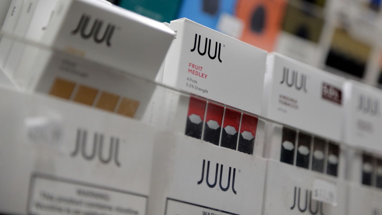 Juul products are displayed at a smoke shop in New York. (AP Photo/Seth Wenig, File)