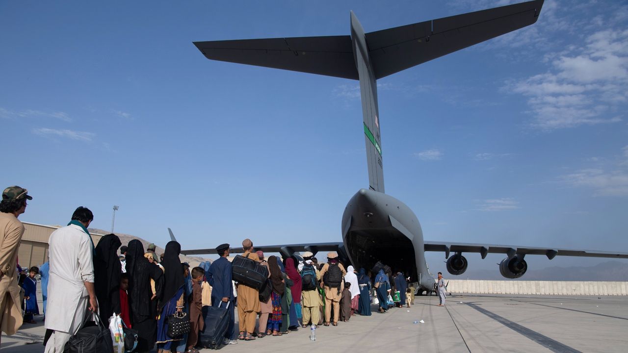 In this image provided by the U.S. Air Force, U.S. Air Force loadmasters and pilots assigned to the 816th Expeditionary Airlift Squadron, load people being evacuated from Afghanistan onto a U.S. Air Force C-17 Globemaster III at Hamid Karzai International Airport in Kabul, Afghanistan, Tuesday, Aug. 24, 2021. (Master Sgt. Donald R. Allen/U.S. Air Force via AP)