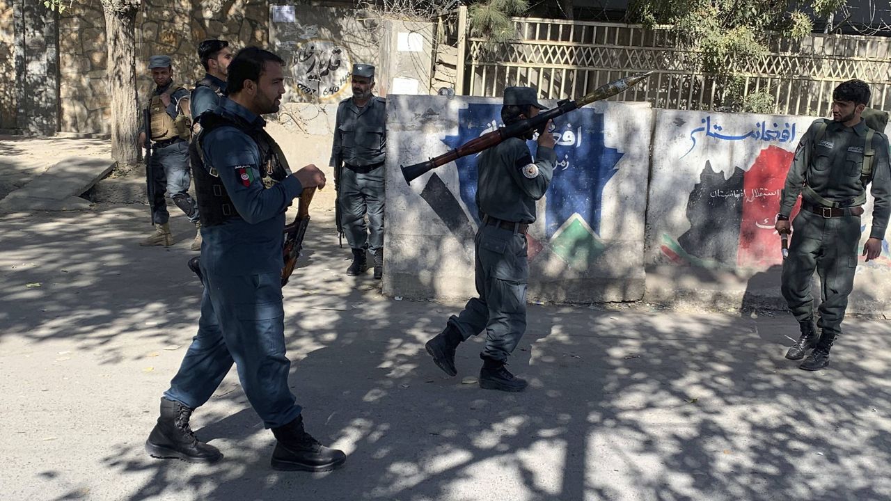 Afghan police arrive at the site of an attack at Kabul University in Kabul, Afghanistan, on Monday. (AP Photo/Rahmat Gul)