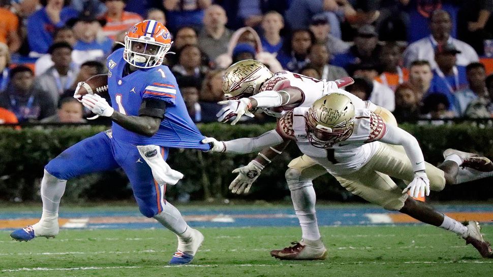 Florida wide receiver Kadarius Toney, left, tries to escape the grasp of Florida State defensive back Levonta Taylor, back right, during the first half of an NCAA college football game Saturday, Nov. 30, 2019, in Gainesville, Fla. (John Raoux/Associated Press)