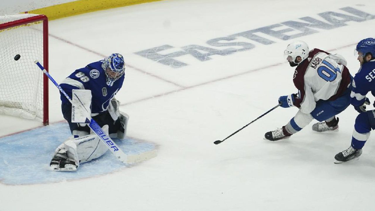 Colorado Avalanche center Nazem Kadri (91) shoots the puck past Tampa Bay Lightning goaltender Andrei Vasilevskiy (88) for a goal during overtime of Game 4 of the NHL hockey Stanley Cup Finals on Wednesday, June 22, 2022, in Tampa, Fla. (AP Photo/John Bazemore)