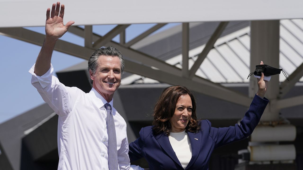 California Gov. Gavin Newsom and Vice President Kamala Harris wave during a campaign event at the IBEW-NECA Joint Apprenticeship Training Center in San Leandro, Calif., Wednesday, Sept. 8, 2021. (AP Photo/Carolyn Kaster)