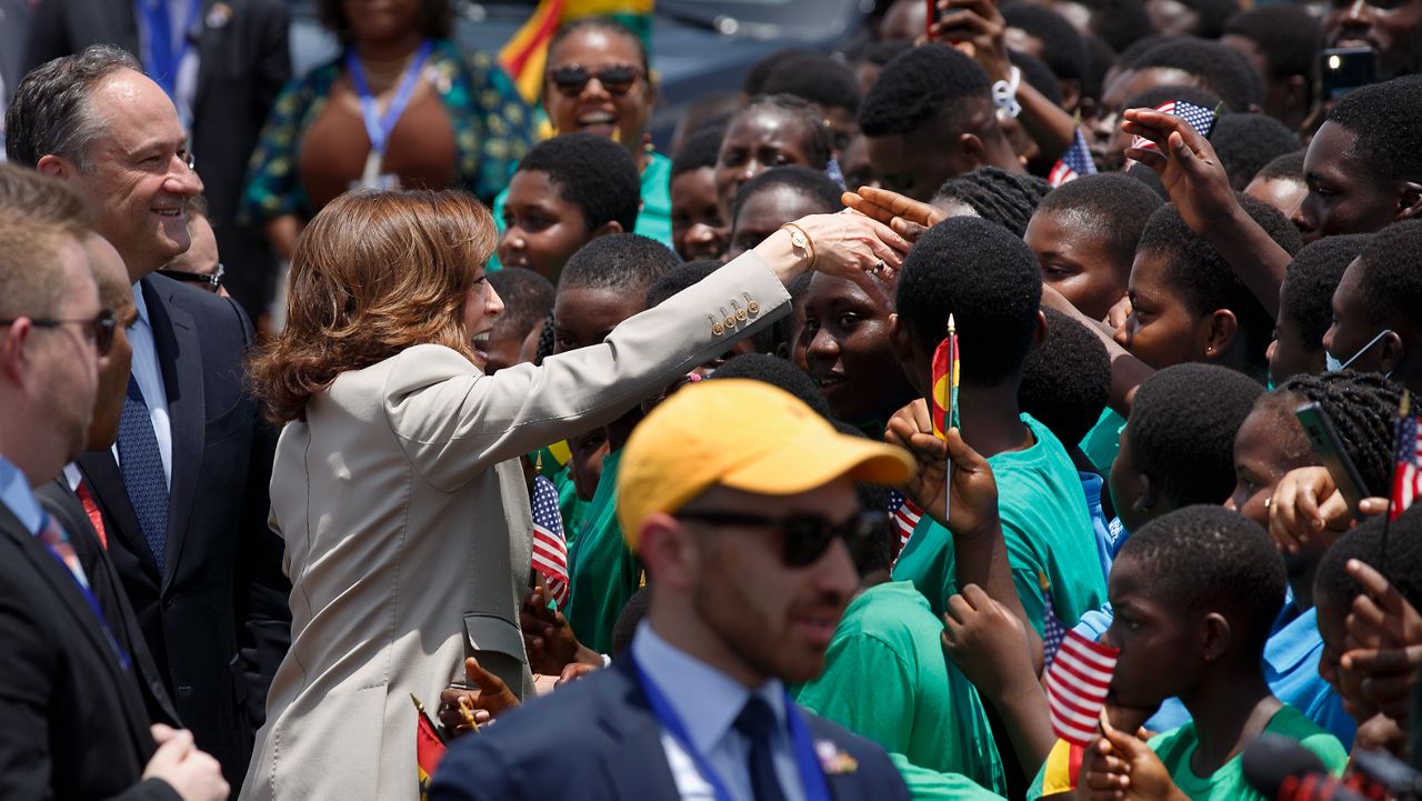 U.S. Vice President Kamala Harris greets school children during her arrival ceremony at Kotoka International Airport in Accra, Ghana Sunday, March 26, 2023. Harris is on a seven-day African visit that will also take her to Tanzania and Zambia. (AP Photo/Misper Apawu)