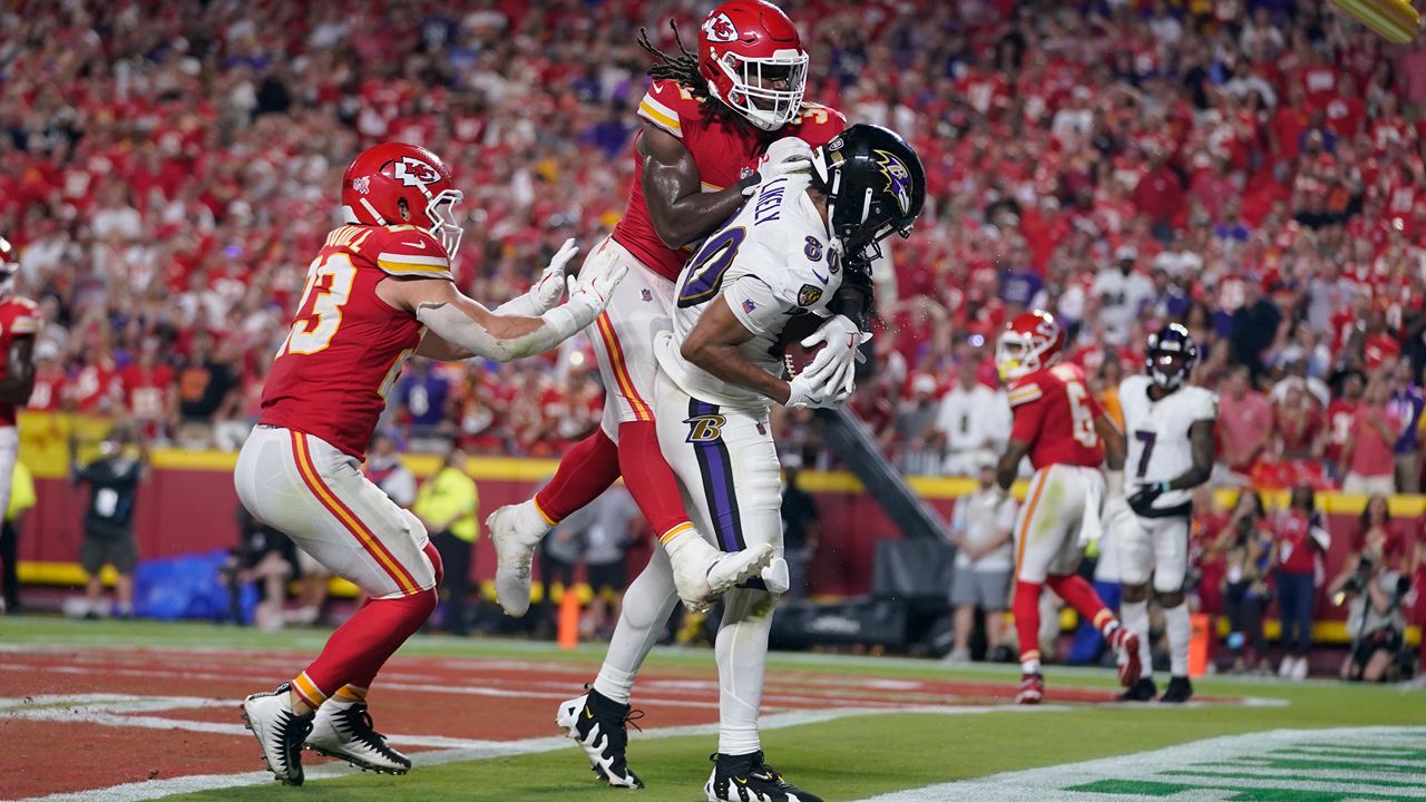 Baltimore Ravens tight end Isaiah Likely (80) catches a pass with his toe out of bounds as Kansas City Chiefs linebacker Nick Bolton  and linebacker Drue Tranquill, left, defend as time time expires in the second half of an NFL football game Thursday, Sept. 5, 2024, in Kansas City, Mo. The Chiefs won 27-20.(AP Photo/Ed Zurga)