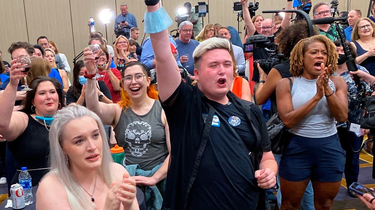 People cheer at a watch party in Overland Park, Kansas, after learning that voters rejected a state constitutional amendment that would have allowed the Legislature to restrict or ban abortion, late Tuesday, Aug. 2, 2022. (Angie Ricono/KCTV5 via AP)