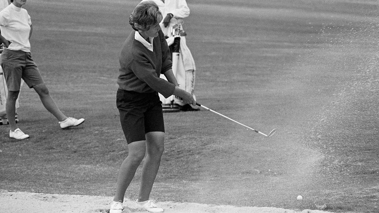 Kathy Whitworth of San Antonio blasts out of sand trap on the 18th green and then sinks a 6-foot putt to go into the lead of the Women Titleholders Golf Tournament at Augusta, Ga., on Nov. 25, 1966. (AP file photo/Horace Cort)