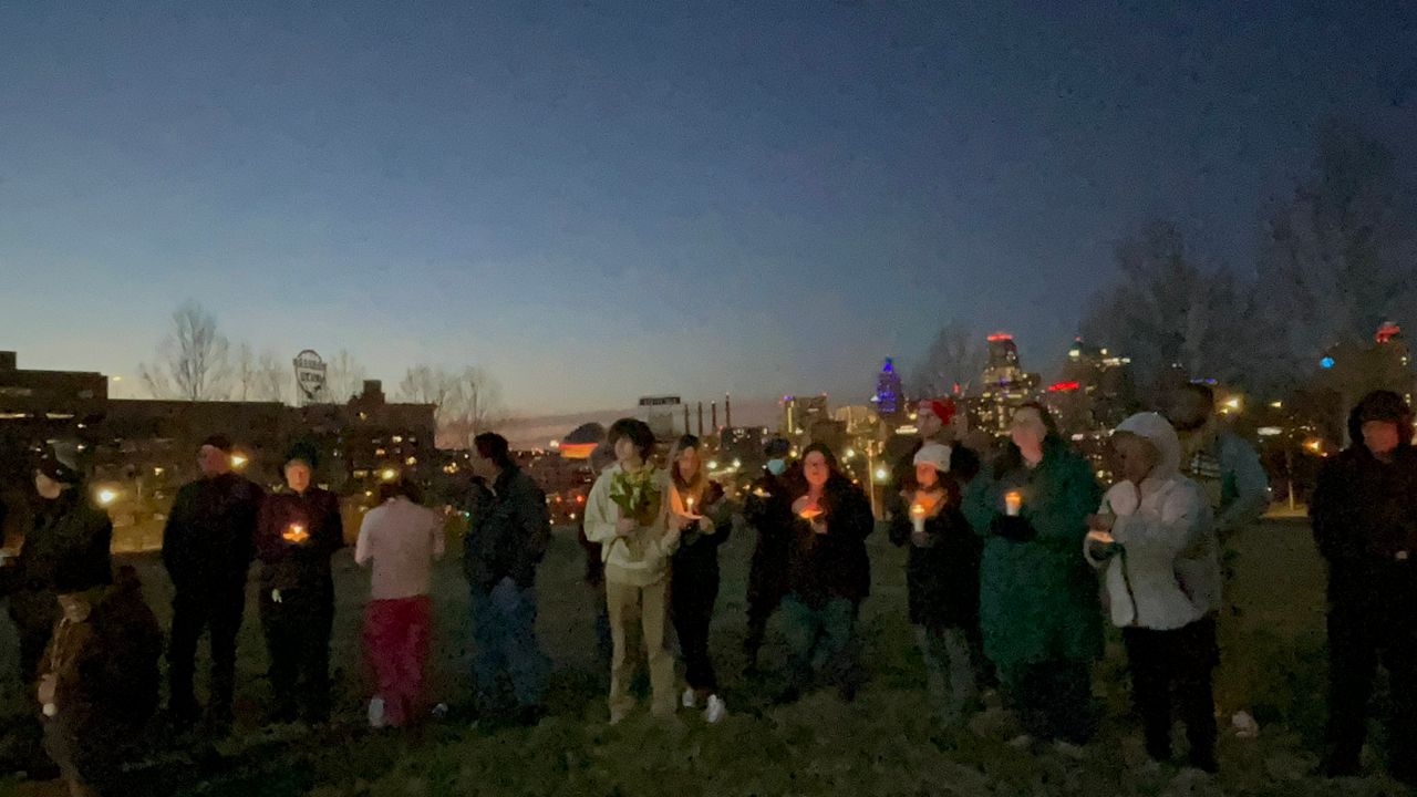 A small crowd gathered at the Skywalk Memorial in Kansas City to honor the victims of the mass shooting following the KC Super Bowl parade. (Spectrum News/Gregg Palermo)