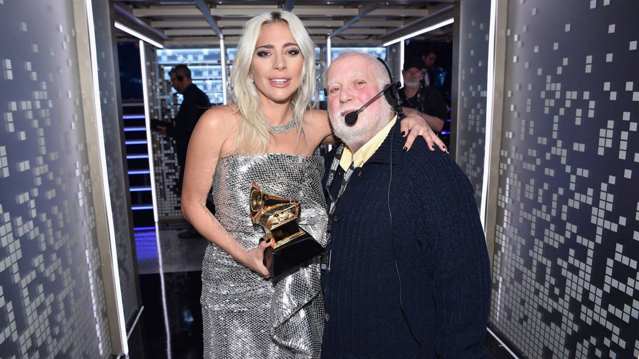 Lady Gaga poses Ken Ehrlich at the Grammy Awards.