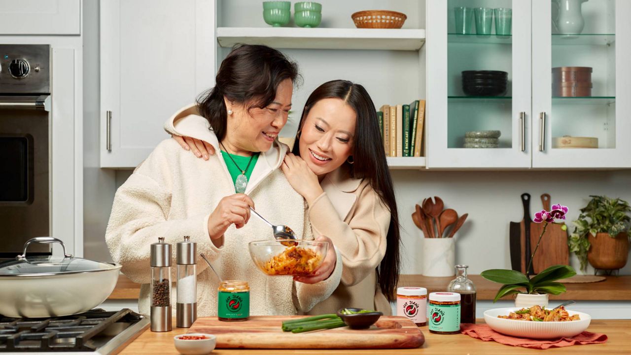 Entrepreneur and producer Kelly Mi Li, right, cooks with her mother. (Photo courtesy of Hot Jiang)