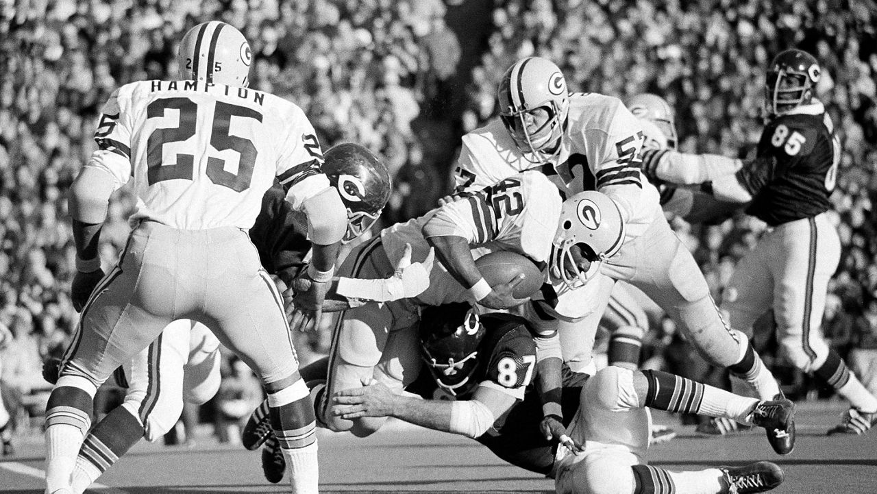 Green Bay Packers running back John Brockington (42) is brought down after a two-yard gain by Chicago Bears defensive end Ed OBradovich (87) in the fourth quarter of an NFL football game