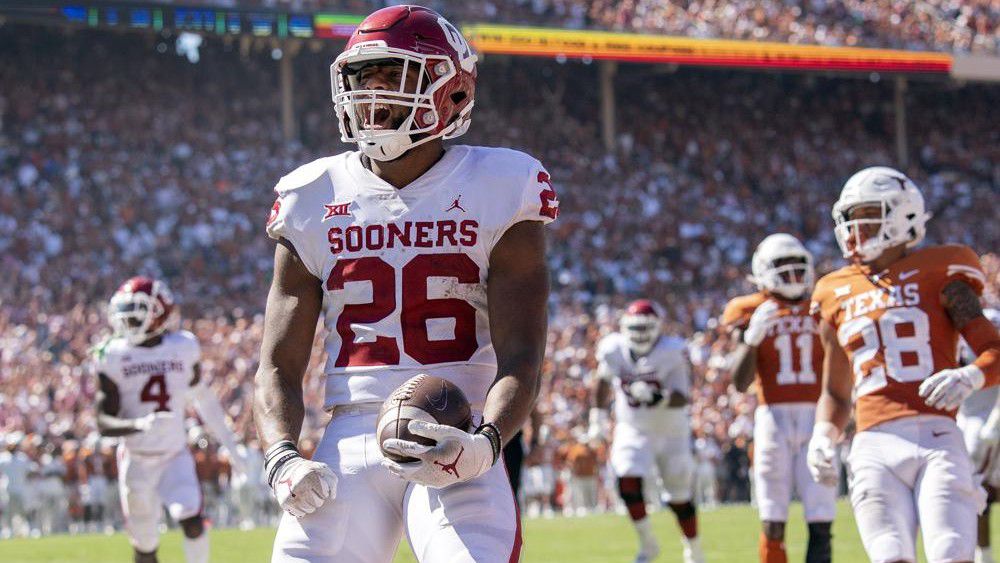 Oklahoma running back Kennedy Brooks (26) runs in for a touchdown against Texas during the fourth quarter of an NCAA college football game at the Cotton Bowl, Saturday, Oct. 9, 2021, in Dallas. Oklahoma won 54-48. (AP Photo/Jeffrey McWhorter)