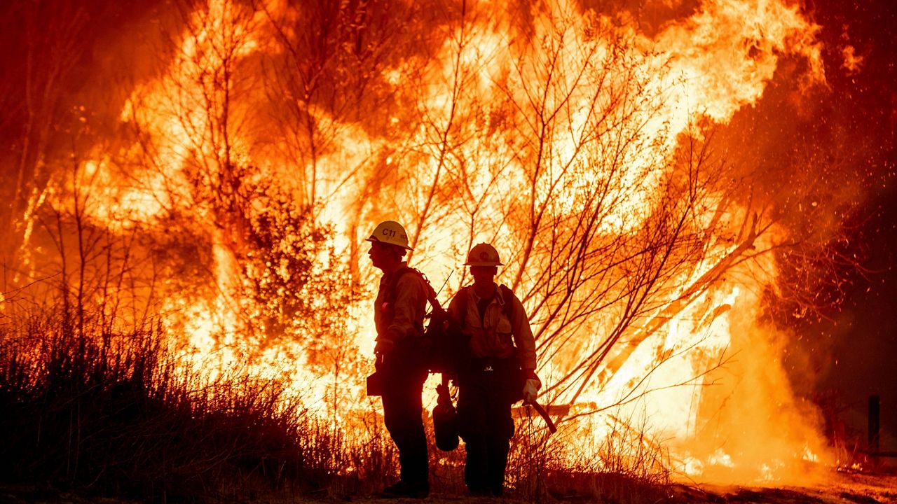 Fire crews battle the Kenneth Fire in the West Hills section of Los Angeles, Thursday, Jan. 9, 2025. (AP Photo/Ethan Swope)