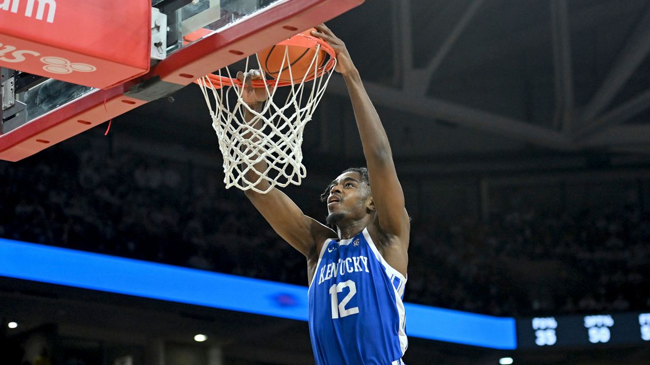 Kentucky guard Antonio Reeves (12) dunks the ball on a fast break against Arkansas during the first half of an NCAA college basketball game Saturday, March 4, 2023, in Fayetteville, Ark. (AP Photo/Michael Woods)