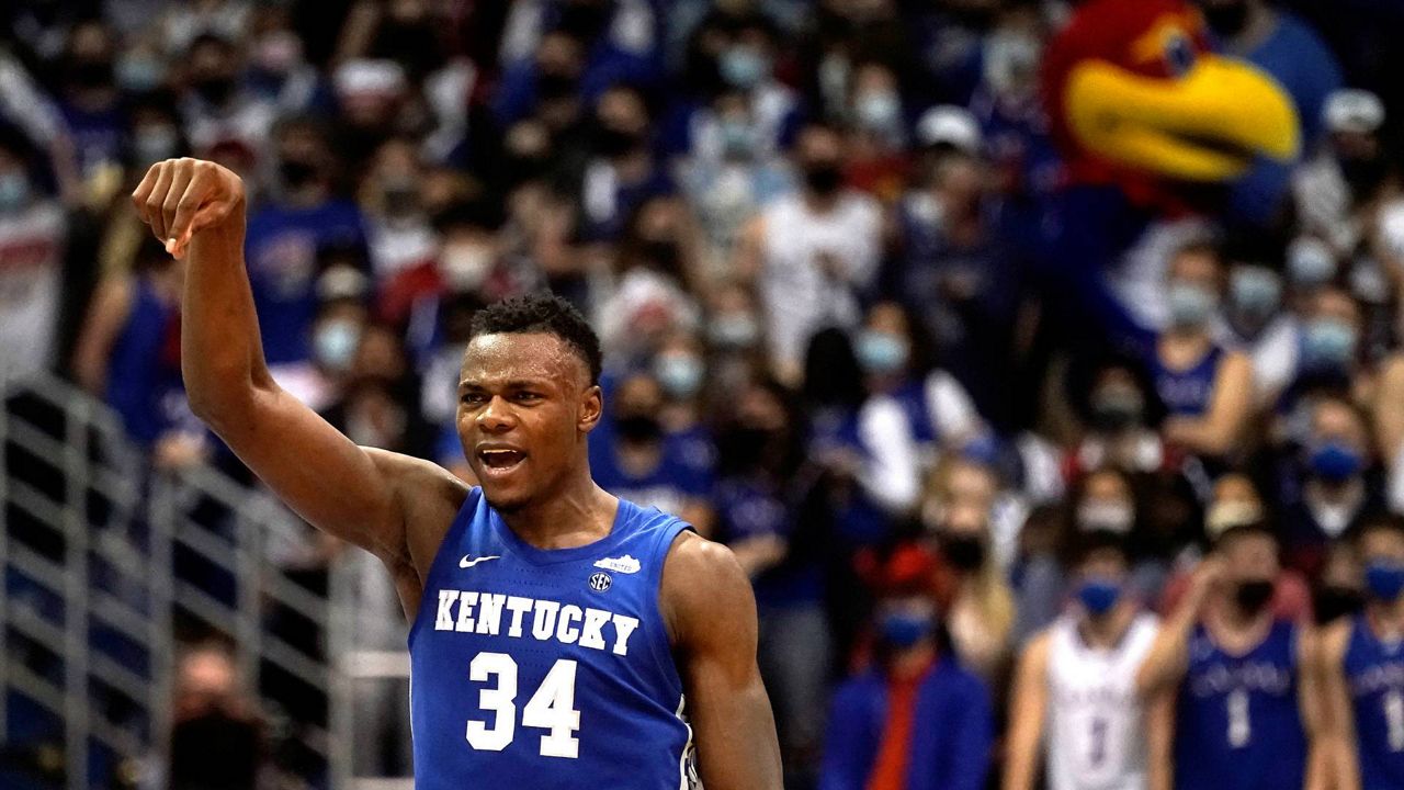 Kentucky forward Oscar Tshiebwe celebrates a basket during the second half of an NCAA college basketball game against Kansas Saturday, Jan. 29, 2022, in Lawrence, Kan. Kentucky won 80-62. (AP Photo/Charlie Riedel)