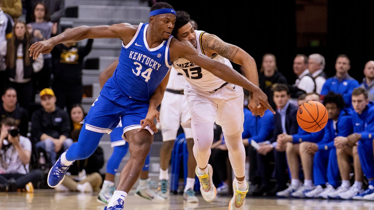 Kentucky's Oscar Tshiebwe, left, and Missouri's Ronnie DeGray III, right, collide as they battle for a loose ball during the first half of an NCAA college basketball game Wednesday, Dec. 28, 2022, in Columbia, Mo. (AP Photo/L.G. Patterson)